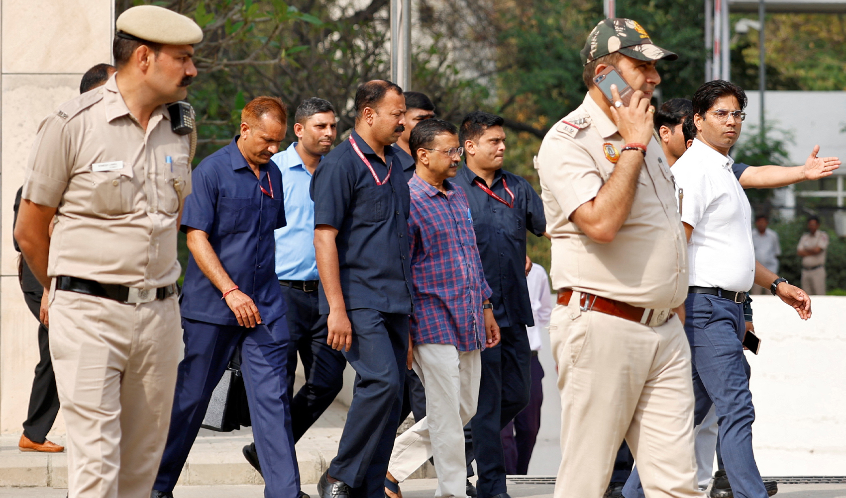 Police officers escort Chief Minister of Delhi and Aam Aadmi Party (AAP) Arvind Kejriwal as he leaves the court after a hearing in New Delhi, India on March 28, 2024. (REUTERS)