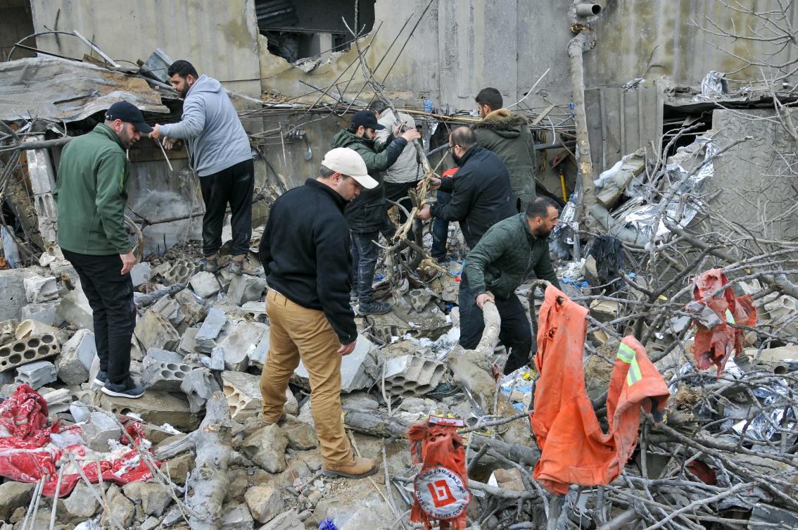 People inspect destruction at the site of an overnight Israeli airstrike in Habariyeh near the Israeli border on Mar. 27, 2024. (AFP)