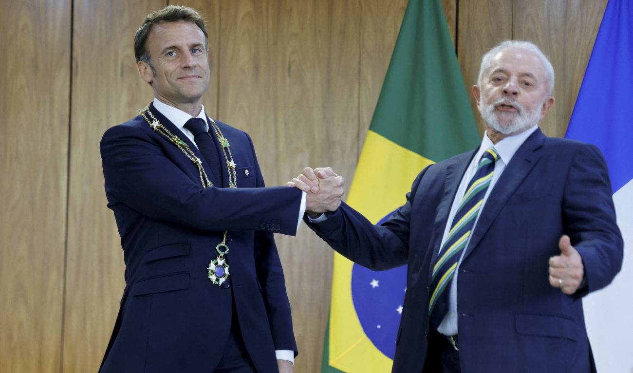 France’s President Emmanuel Macron (L) wears the Order of the Southern Cross decoration while posing for a picture with Brazil’s President Luiz Inacio Lula da Silva (R) at the Planalto Palace in Brasilia, on March 28, 2024. (AFP)
