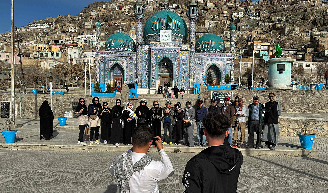 In this picture taken on March 25, 2024 Thai tourists pose for a group picture during their visit to the Kart-e-Sakhi Shrine in Kabul. (AFP)