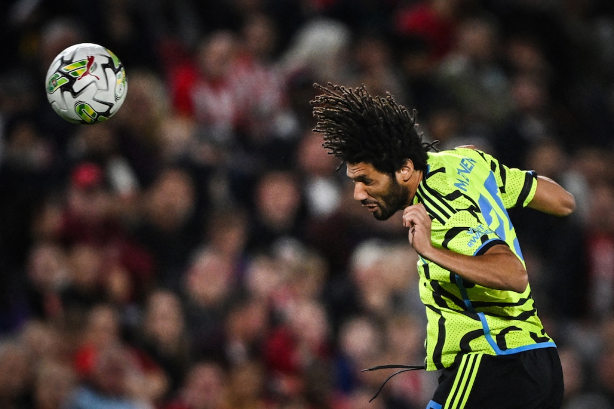 Arsenal's Egyptian midfielder #25 Mohamed Elneny heads the ball during the English League Cup third round football match between Brentford and Arsenal at the Brentford Community Stadium in London. (AFP)