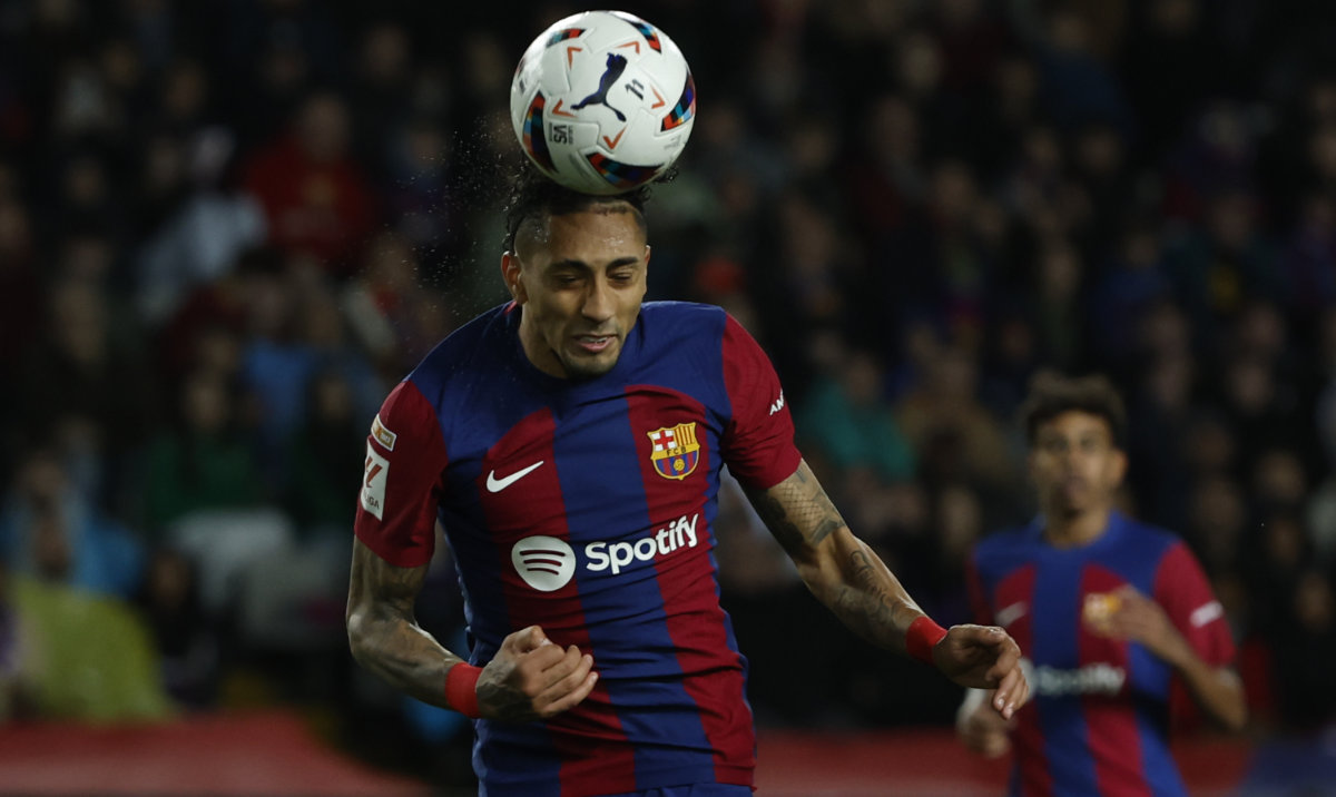 Barcelona's Raphinha heads the ball to scores his side's opening goal during a Spanish La Liga soccer match between Barcelona and Las Palmas at the Olimpic Lluis Companys stadium in Barcelona on March 30, 2024. (AP)