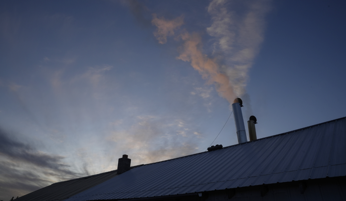 Steam bellows out of a chimney at Jeremy Solin's sugar shack, Sunday, Feb. 25, 2024, in Deerbrook, Wis. (AP)