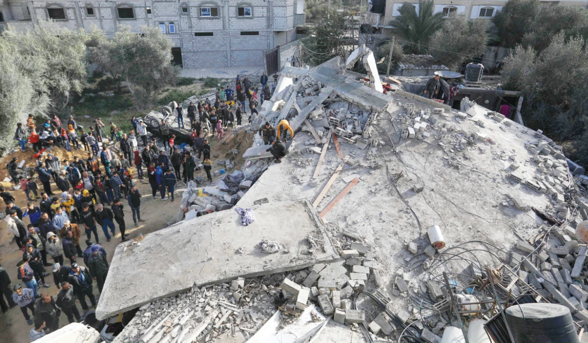 Palestinians check the rubble of a house destroyed in an Israeli airstrike in Rafah in the southern Gaza Strip on Sunday as the conflict between Israel and Hamas continues. (AFP)