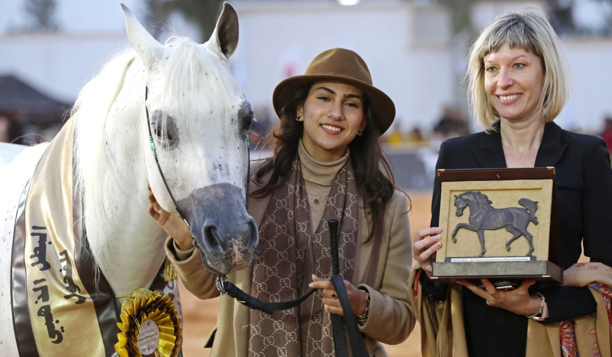 Participants pose with their Best in Show trophy after taking part in the National Championship of Libyan Arabian Horse (Elkheir Cup) on the outskirts of Tripoli on March 3, 2024. (AFP)
