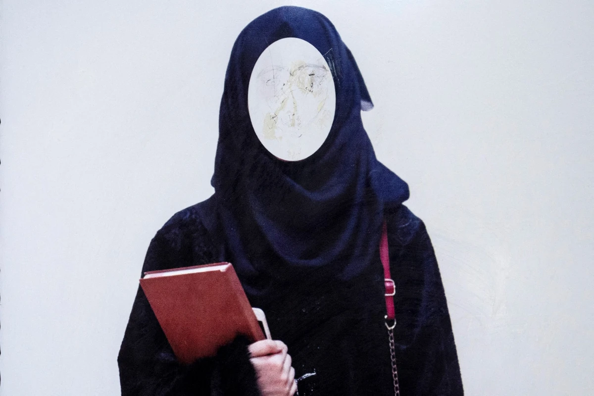 A poster ordering women to cover themselves with a hijab is pictured at a private university in Kabul, Afghanistan, on March 6, 2023. (AFP/File)