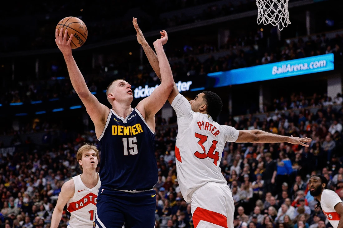 Denver Nuggets center Nikola Jokic attempts a shot against Toronto Raptors center Jontay Porter in the third quarter of their NBA game Monday at Ball Arena. (Supplied)