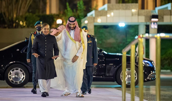 A handout picture provided by the Saudi Royal Palace shows Saudi Arabia's Crown Prince Mohammed Bin Salman (R) welcoming Pakistani Prime Minister Shehbaz Sharif in Jeddah on April 30, 2022. (AFP/File)