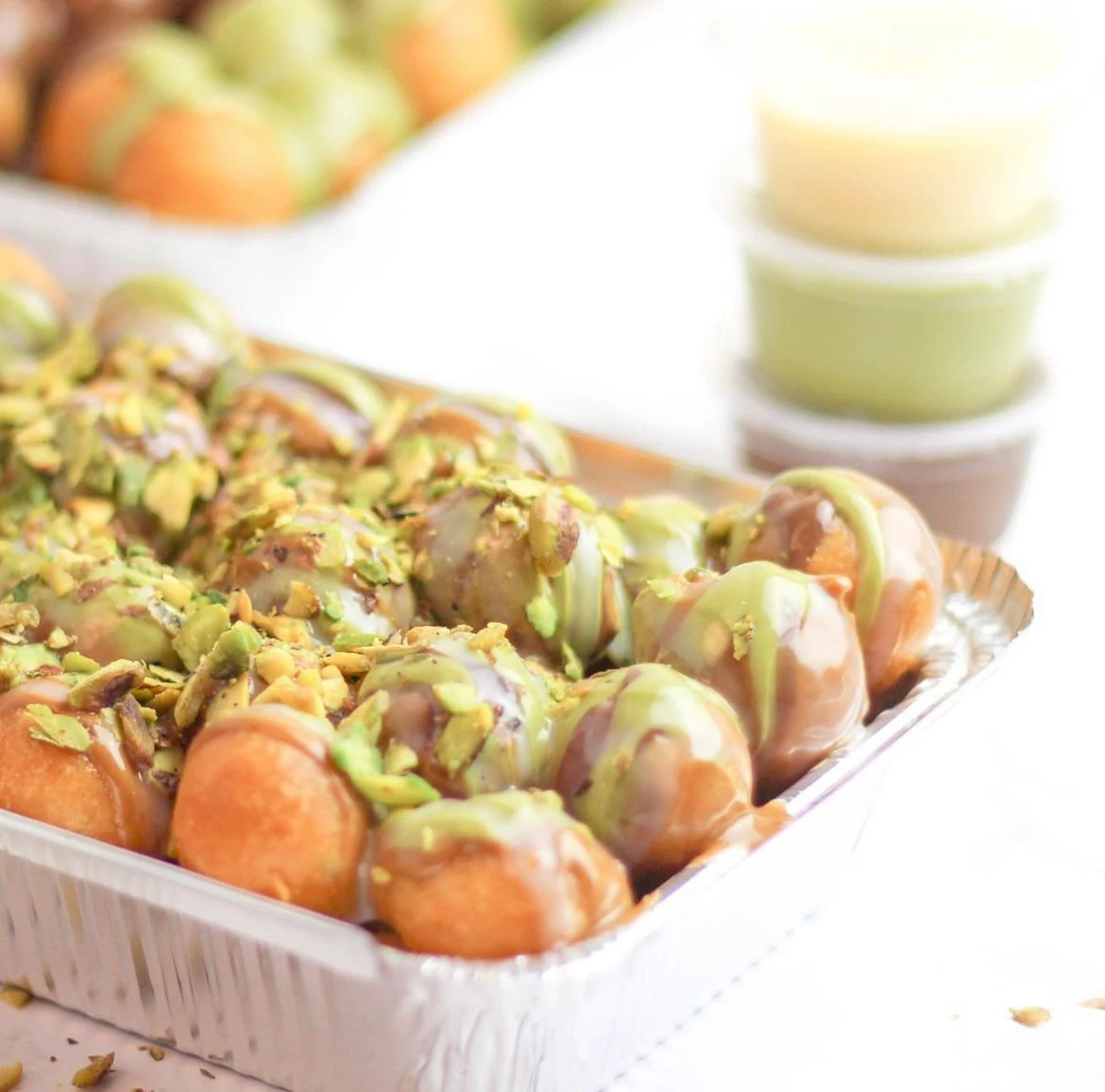 Logaimat is deep fried dough soaked in honey, syrup or molasses and then topped off with sesame or nuts depending on the cuisine. (Supplied)