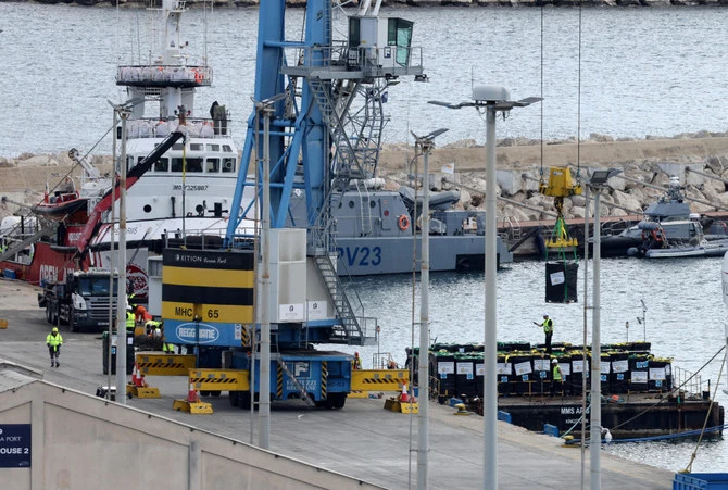Humanitarian aid for Gaza is loaded onto a platform next to a Spanish NGO Open Arms rescue vessel at the port of Larnaca on Mar. 9, 2024. (Reuters)