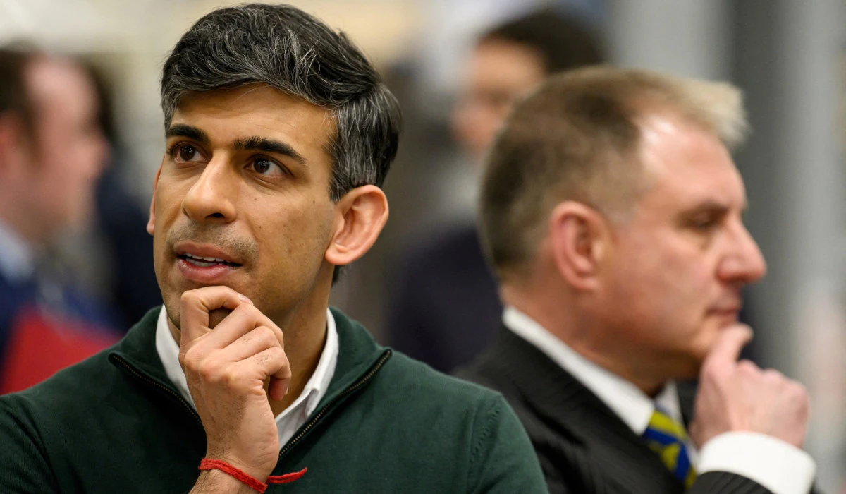 Britain's Prime Minister Rishi Sunak and Conservative MP for Filton and Bradley Stoke Jack Lopresti listen to information on engine development during a visit to the Rolls-Royce manufacturing facility in Bristol, Britain, March 14, 2024. (REUTERS)