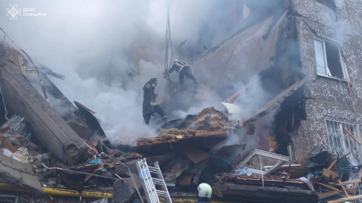 Ukrainian rescuers work at the site where a residential building was severely damaged after a Russian drone attack in the northern region of Sumy on March 13, 2024. (Handout via REUTERS)