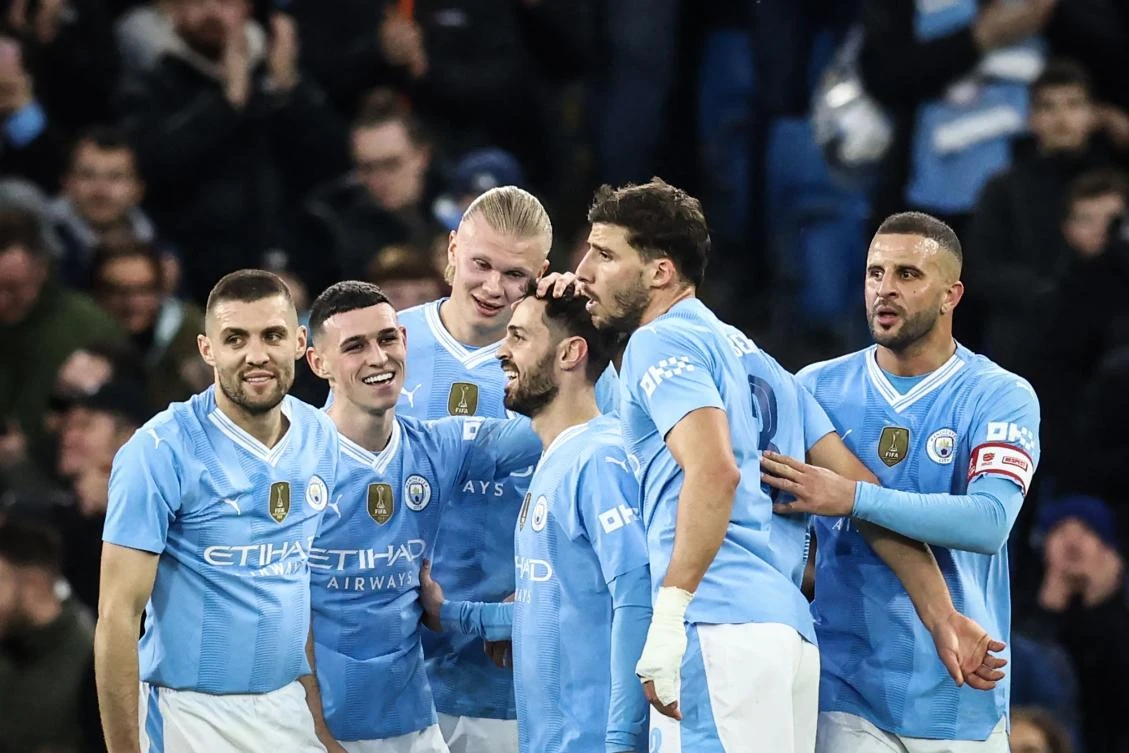 Manchester City’s Portuguese midfielder Bernardo Silva celebrates with teammates after scoring his team second goal during their English FA Cup Quarter Final match against Newcastle United at the Etihad Stadium in Manchester on Mar. 16, 2024. (AFP)