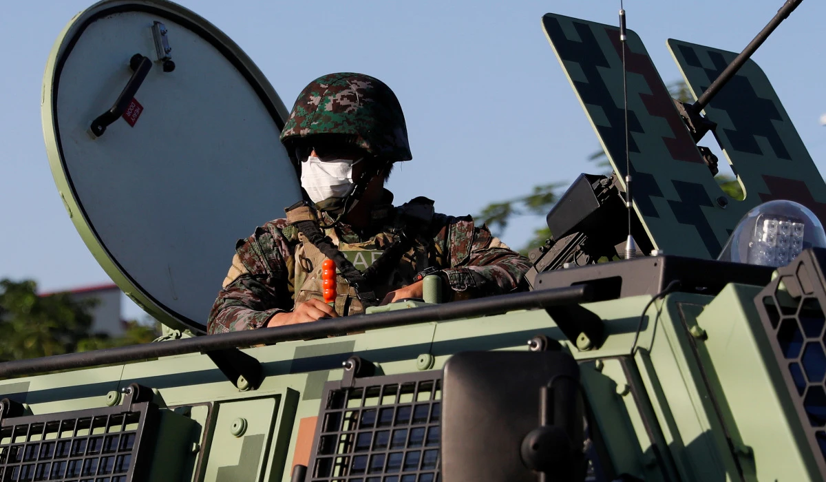 A police officer on board an armored vehicle patrols in Metro Manila, Philippine. (REUTERS)