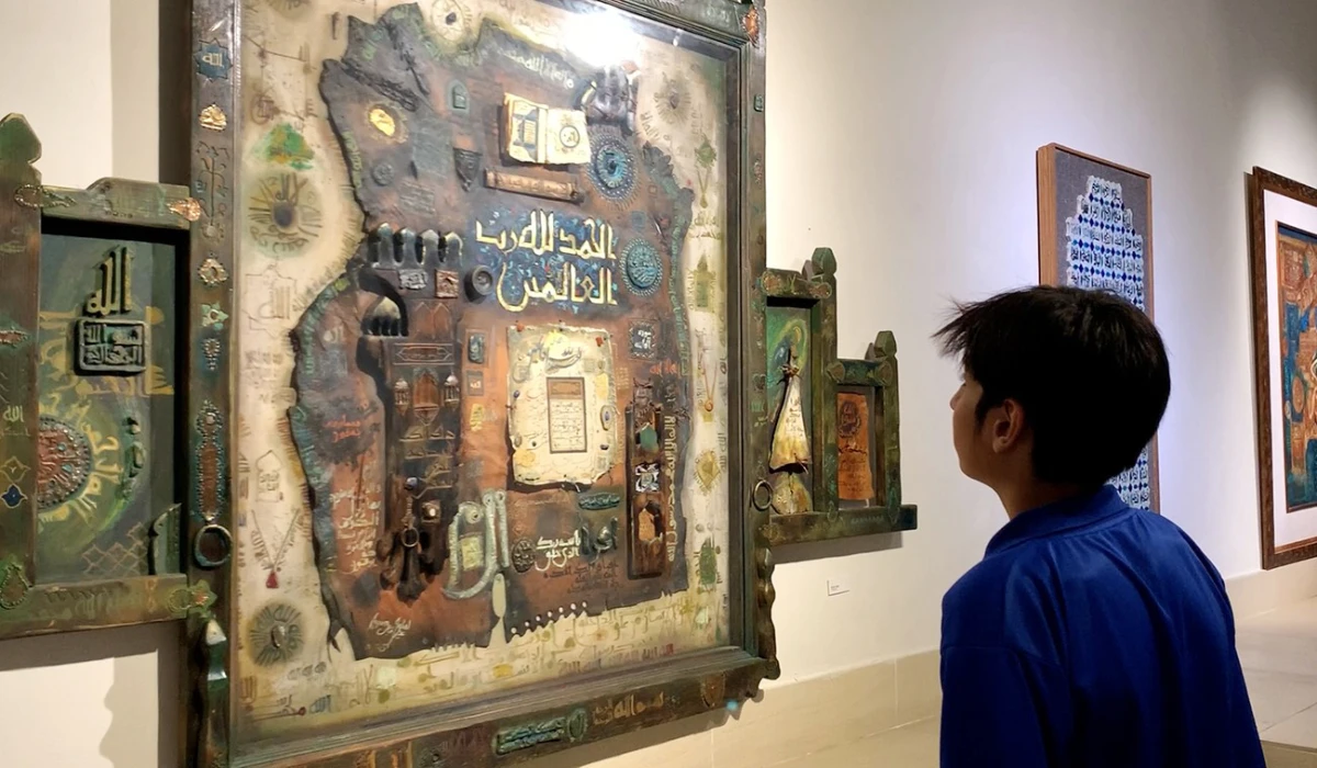 A visitor looks at a painting exhibited at Ramadan exhibition showcasing Qur’anic calligraphy by leading artists at the Pakistan National Council of the Arts in Islamabad. (AN photo)
