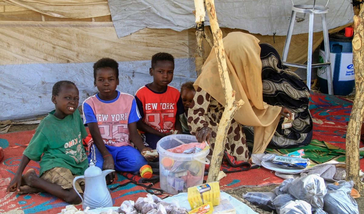 A picture taken on March 20, 2024, shows people who fled Khartoum and Jazira states in war-torn Sudan sitting in a tent at a camp for the internally displaced in southern Gadaref state. (AFP/File)