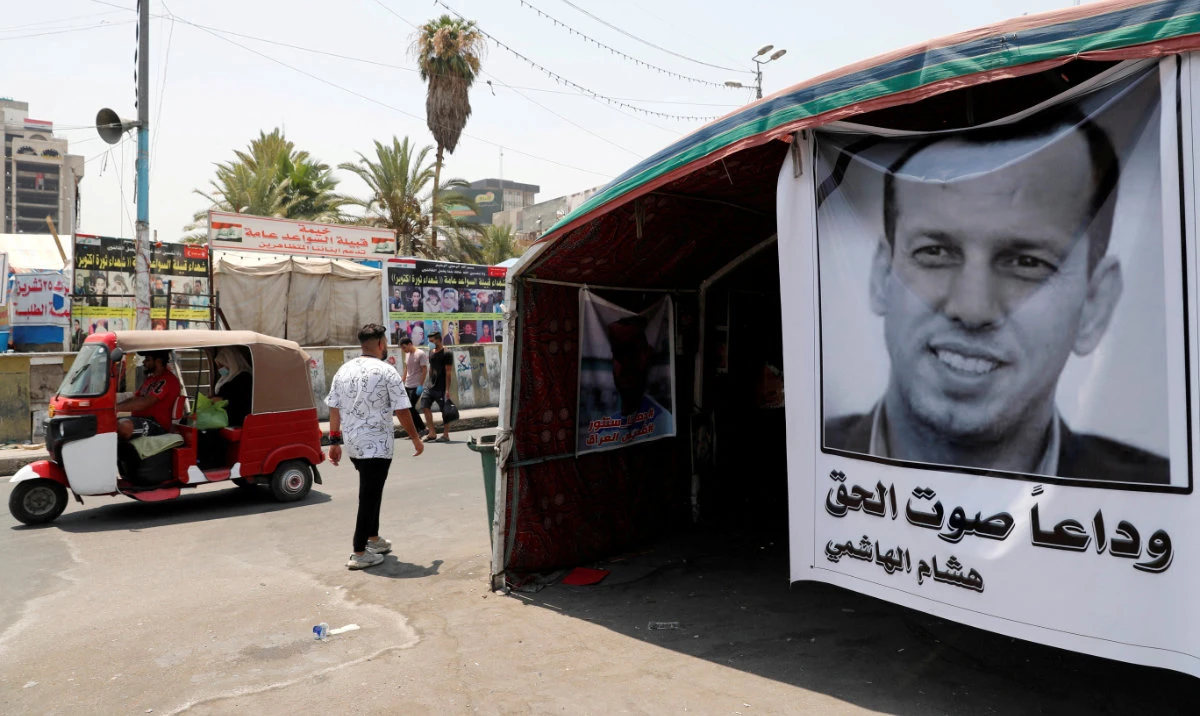A poster depicting the former government advisor and political analyst Hisham Al-Hashemi, who was killed by gunmen is seen at the Tahrir Square in Baghdad, Iraq. (Reuters/File)