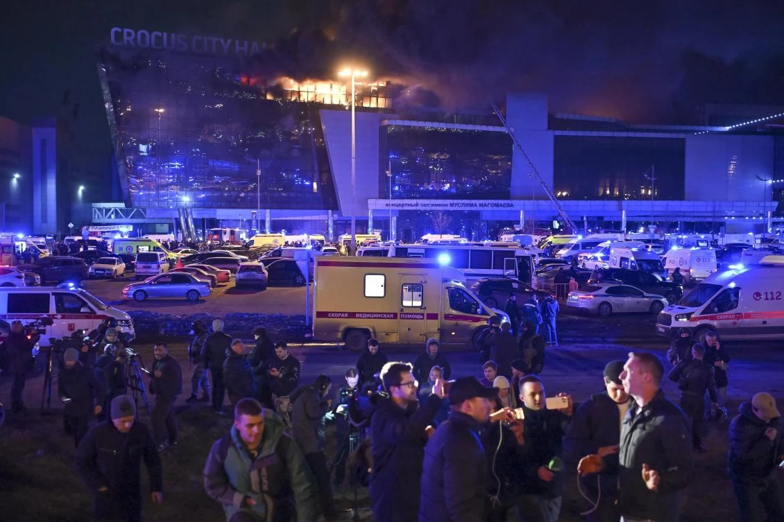 A man speaks to journalists as a massive blaze seen over the Crocus City Hall on the western edge of Moscow, Russia, on Mar. 22, 2024. (AP)