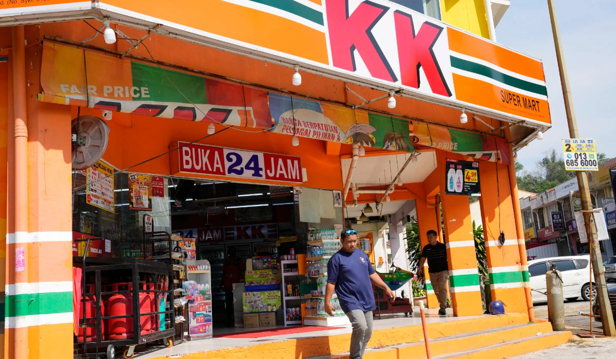 A customer walk out from KK Mart convenience store in Puchong area on the outskirts of of Kuala Lumpur, Malaysia, Tuesday, March 26, 2024. (AP)