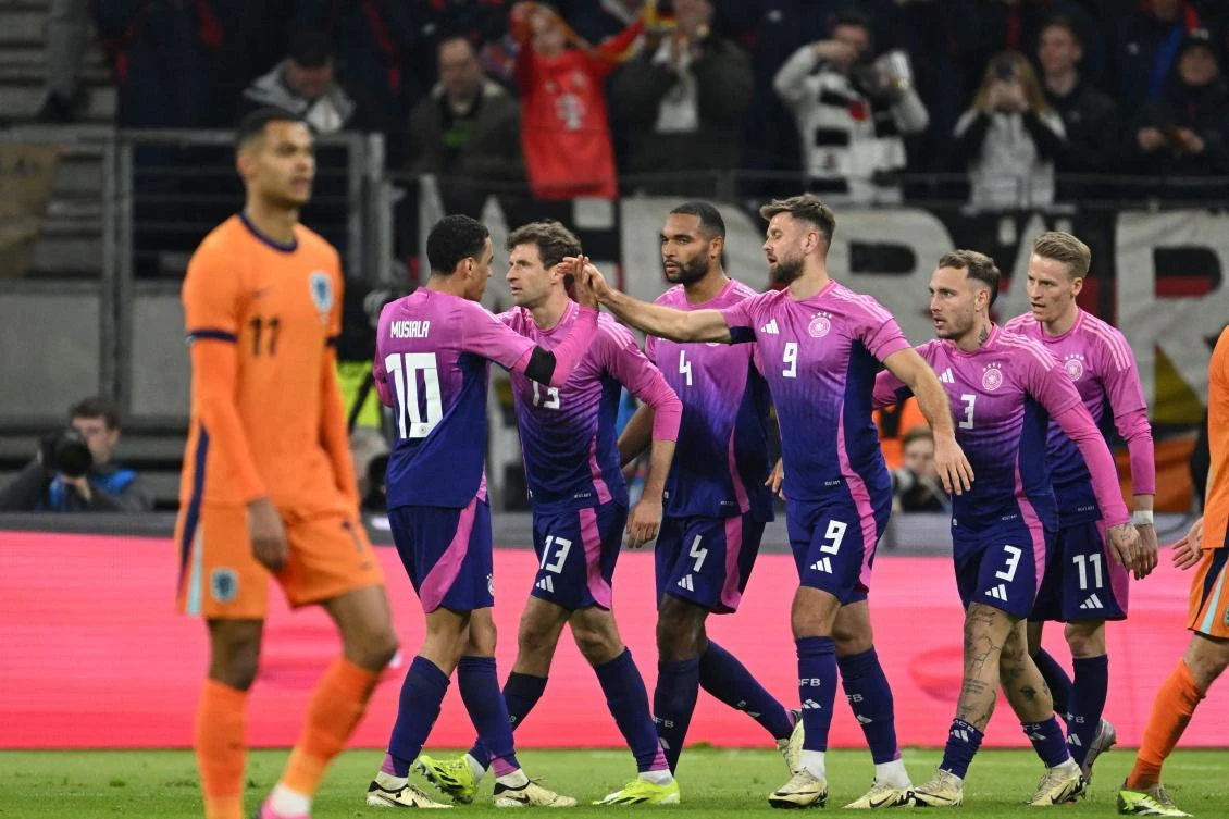 Germany’s forward Niclas Fullkrug celebrates with team mates after scoring the 2-1 goal during their friendly match against the Netherlands in Frankfurt on Mar. 26, 2024. (AFP)