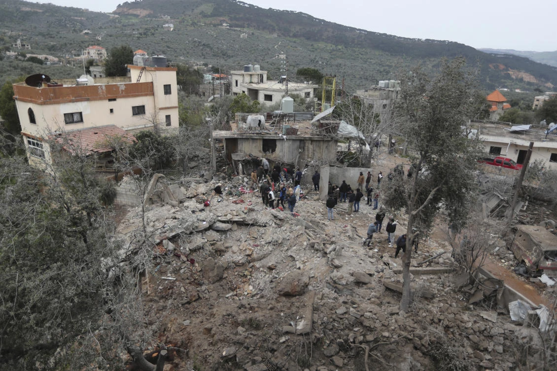 People gather on the rubble of a paramedic center that was destroyed by an Israeli airstrike early Wednesday in Hebbariye village, south Lebanon, on Mar. 27, 2024. (AP)