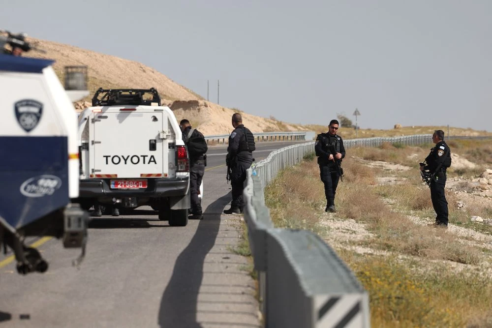 Above, Israeli security forces stand guard on a road in the occupied West Bank following a shooting attack on March 28, 2024. ( AFP)