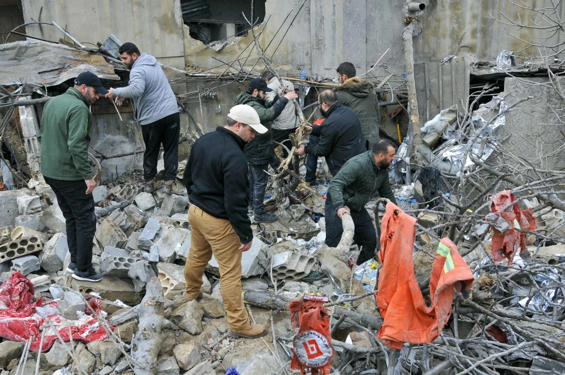 People inspect destruction at the site of an overnight Israeli airstrike in Habariyeh near the Israeli border on Mar. 27, 2024. (AFP)