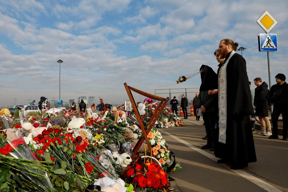 Clergymen conduct a memorial service for victims at a makeshift memorial near the Crocus City Hall following a deadly attack on the concert venue outside Moscow on Mar. 29, 2024. (Reuters)