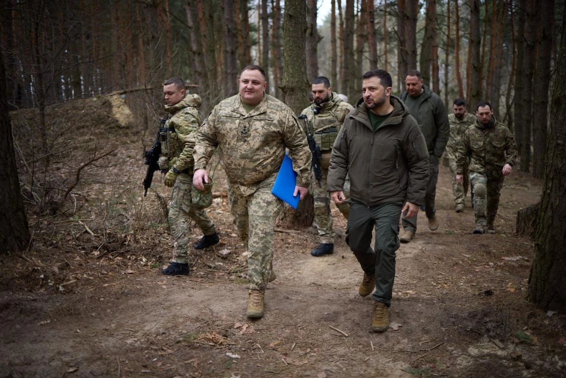 This handout photograph taken and released by Ukrainian Presidential press service on Mar. 27, 2024, shows Ukraine’s President Volodymyr Zelensky walking with Ukrainian servicemen on the location of the 117th separate brigade of territorial defense in the Sumy region. (AFP)