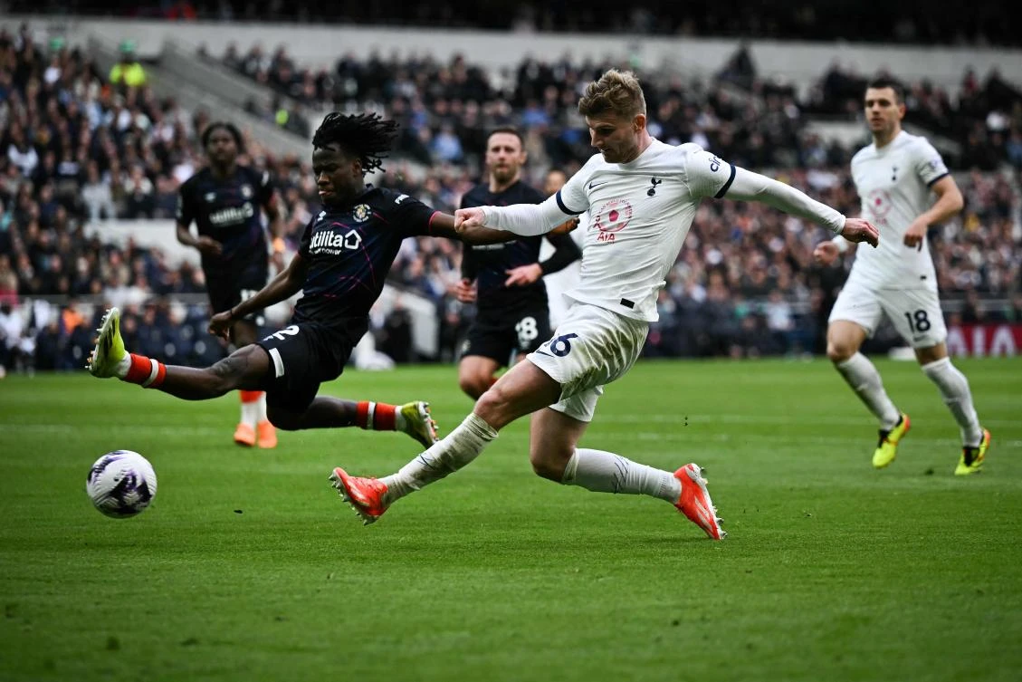 Luton Town’s Burkinese defender Issa Kabore (R) jumps to stop the shot by Tottenham Hotspur’s German striker Timo Werner but ends up scoring an own goal during their English Premier League match at the Tottenham Hotspur Stadium in London, on Mar. 30, 2024. (AFP)