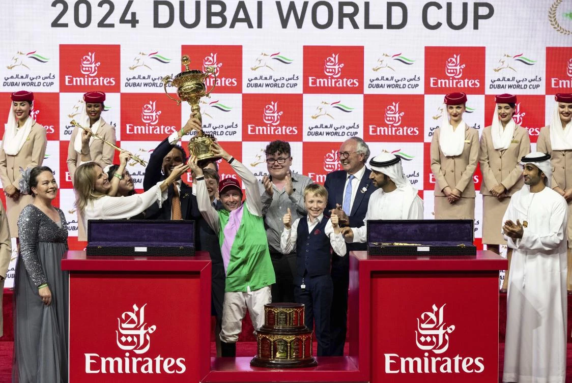 Laurel River’s jockey Tadhg O’Shea lifts the trophy after winning Group 1 Dubai World Cup over 2000m (10 furlongs) at Meydan Racecourse in Dubai, on Mar. 30, 2024. (AP)