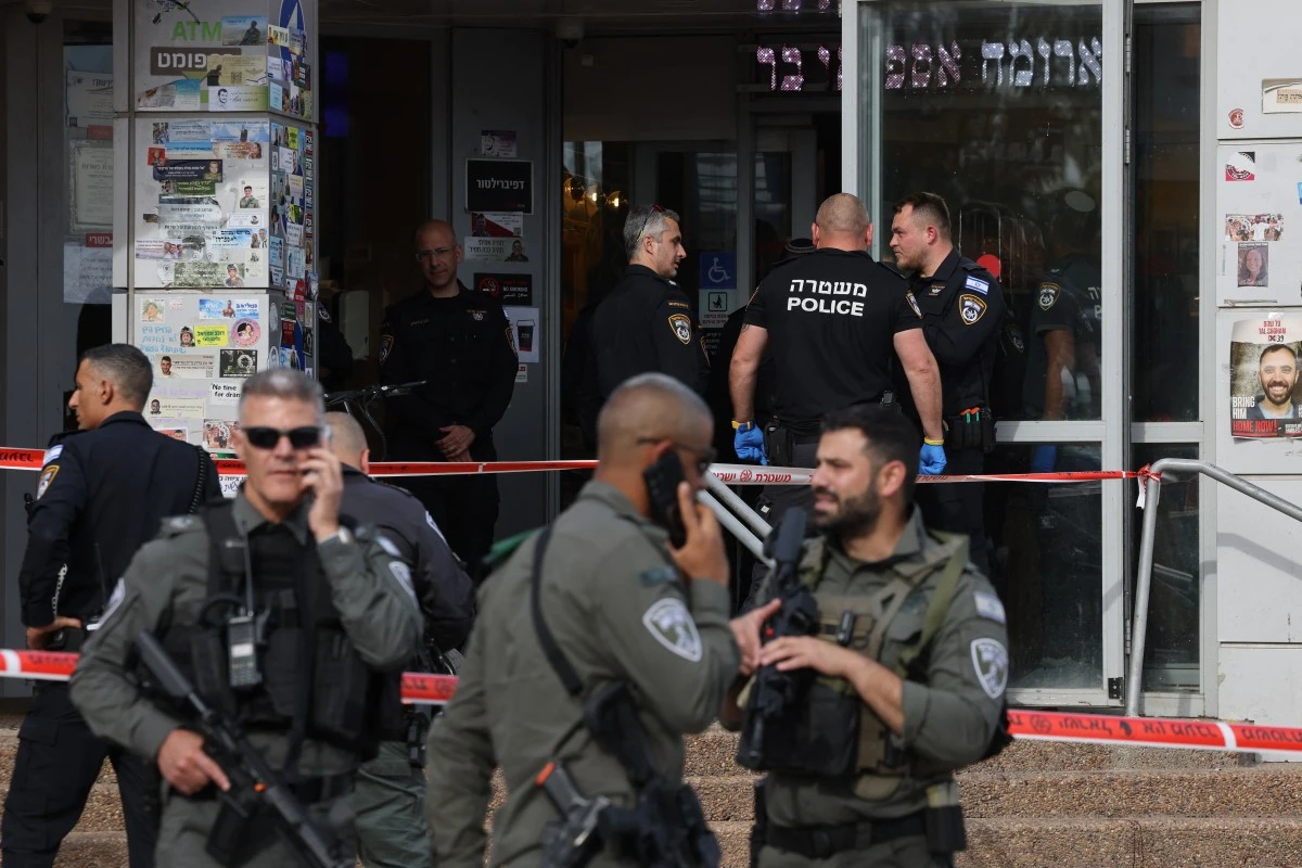 File photo of Israeli security forces and police officers gathering at the site of a reported stabbing attack at a shopping centre in Beit Kama in southern Israel (AFP)