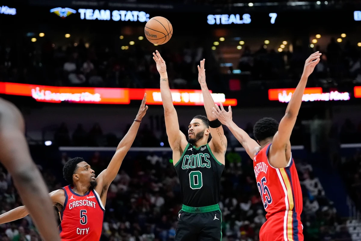 Boston Celtics forward Jayson Tatum shoots between New Orleans Pelicans forward Herbert Jones (5) and guard Trey Murphy III in the second half of an NBA basketball game in New Orleans Saturday. The Celtics won 104-92. (AP)