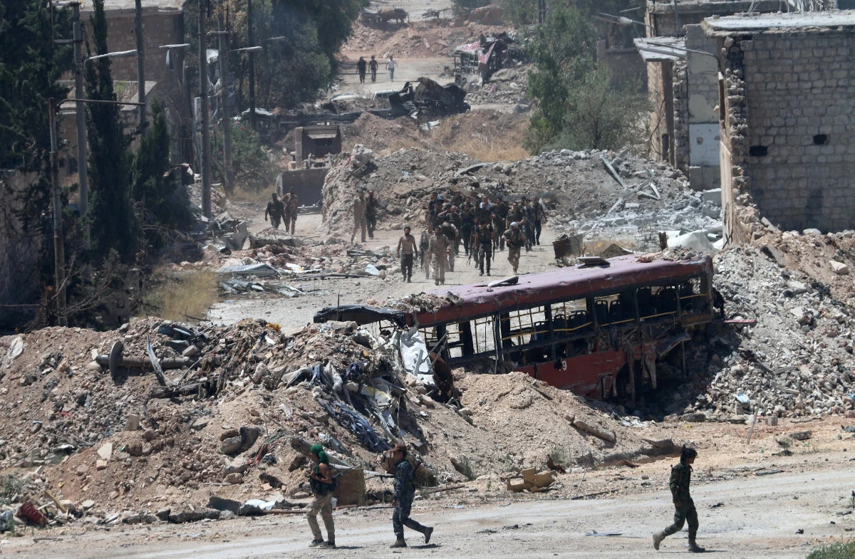 File photo shows Syrian Army soldiers on patrol in Bani Zeid in the northwest outskirts of Aleppo. (AFP)