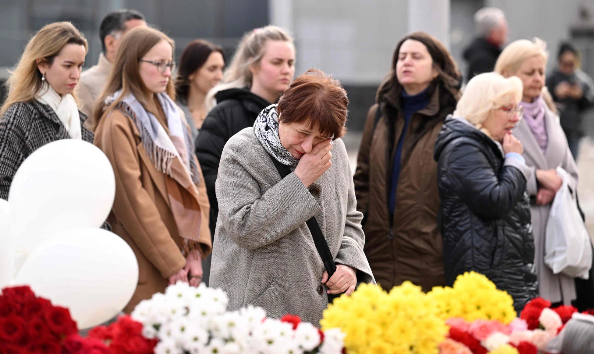 A woman cries at a makeshift memorial in front of the burnt-out Crocus City Hall concert venue in Krasnogorsk, Moscow. (AFP)