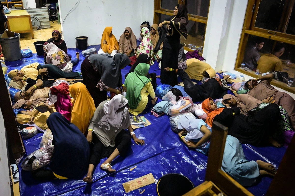 Newly arrived Rohingya refugees rest at their shelter in Meulaboh, West Aceh, on March 23, 2024. (AFP)