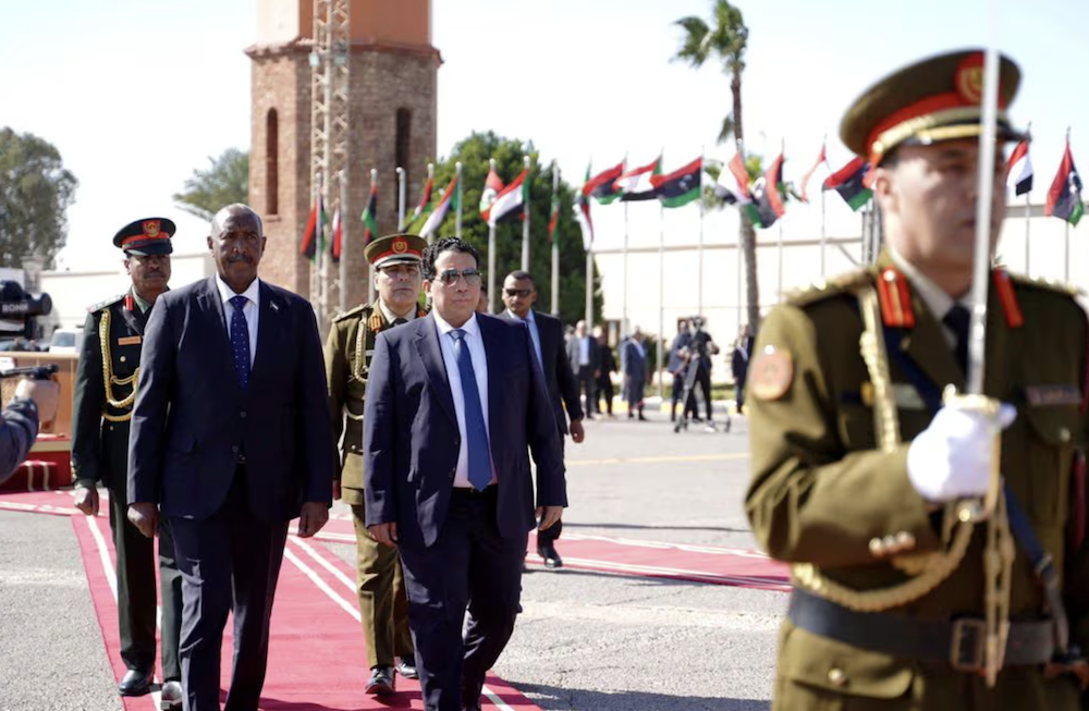 Head of the Libyan Presidential Council Mohamed Al-Menfi meets Sudan's Sovereign Council Chief General Al-Burhan. (Reuters)