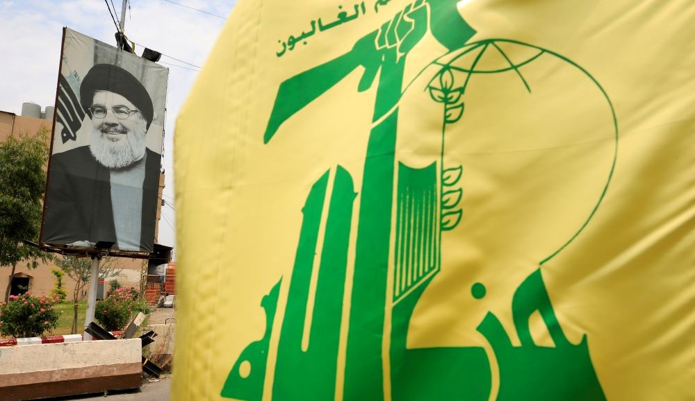 A Hezbollah flag and a poster of the movement’s leader Hassan Nasrallah on a street, Sidon, Lebanon, July 7, 2020. (Reuters)