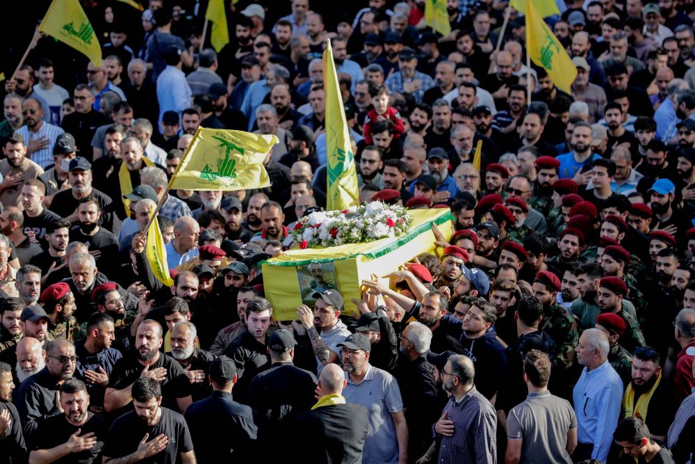 Hezbollah fighters carry the coffin of Commander Ahmed Shehimi, who was killed in an Israeli raid on Syria, Mar. 29, during his funeral procession in southern Beirut, Lebanon, Apr. 1, 2024. (AFP)