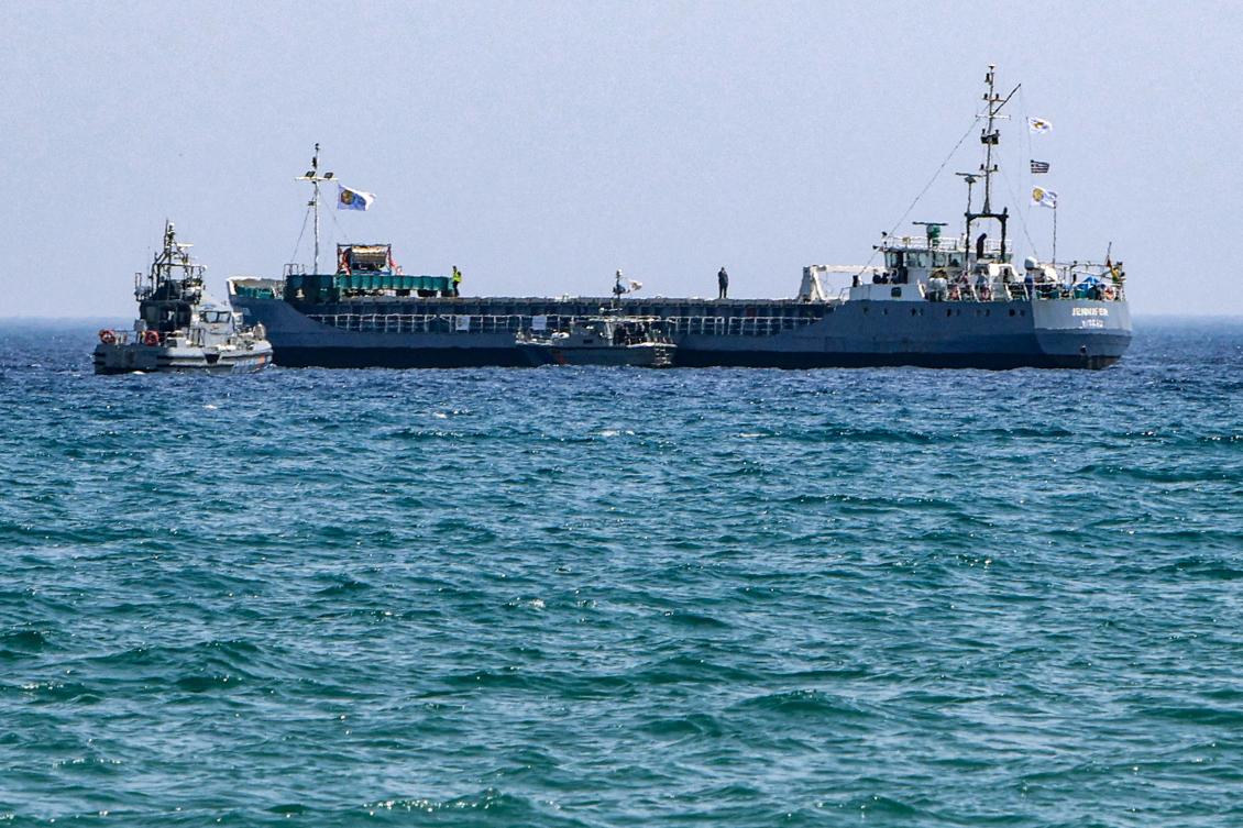 A Cyprus Coast Guard patrol boat approaches the Guinea-Bissau-flagged cargo ship Jennifer, carrying food aid provided by US charity World Central Kitchen (WCK) bound for the Gaza Strip, off the coast of Cyprus’ southern port city of Laranca on Mar. 30, 2024. (AFP)