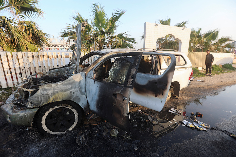 A person looks at a vehicle where employees from the World Central Kitchen (WCK), including foreigners, were killed in an Israeli airstrike, according to the NGO as the Israeli military said it was conducting a thorough review. (Reuters)