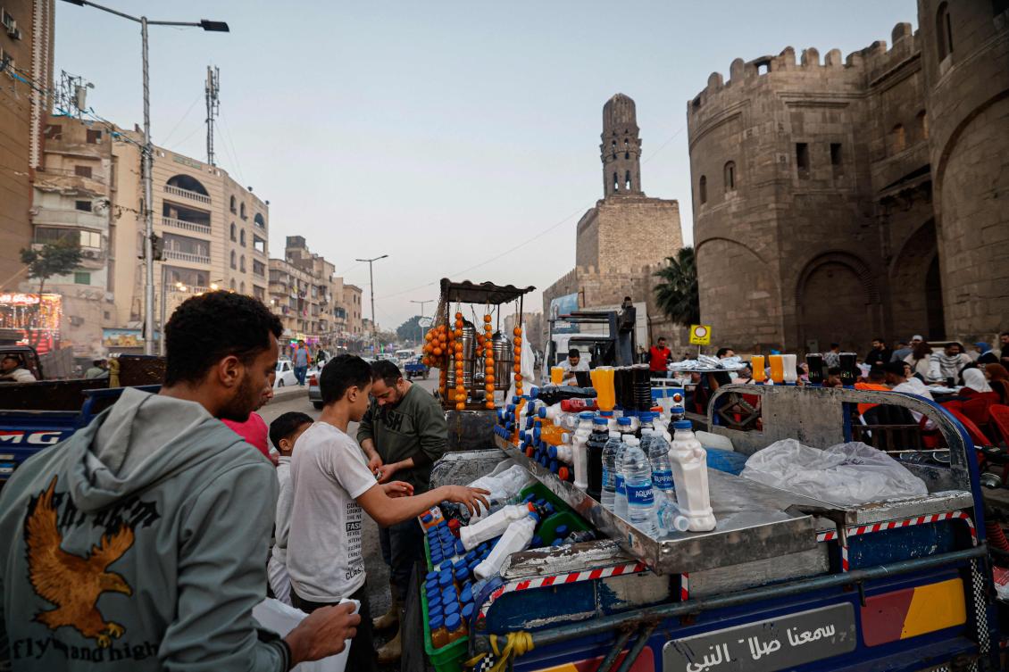 A vendor sells juice for people to break their fast during the Muslim holy month of Ramadan at sunset outside Bab Al-Futuh (Gate of Conquests), one of the three remaining medieval gates of the old city walls of Cairo built at the end of the 11th century (AFP)