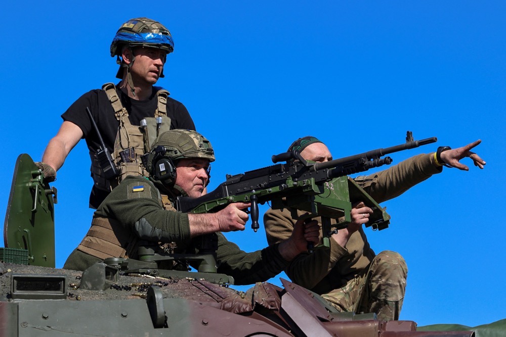 Service members of the 37th Marine Brigade of the Ukrainian Armed Forces use a machine gun atop of a French AMX-10 RC armoured fighting vehicle during military drills. (Reuters)