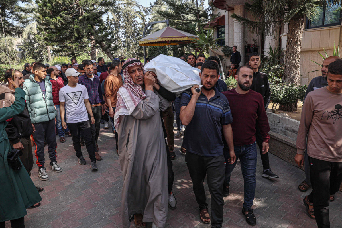 Relatives and friends carry the body of World Central Kitchen worker Saif Abu Taha during his funeral in Rafah in the southern Gaza Strip on April 2, 2024. He was killed as Israeli strikes hit a convoy of the US-based NGO delivering food aid in Gaza a day earlier. (AFP)