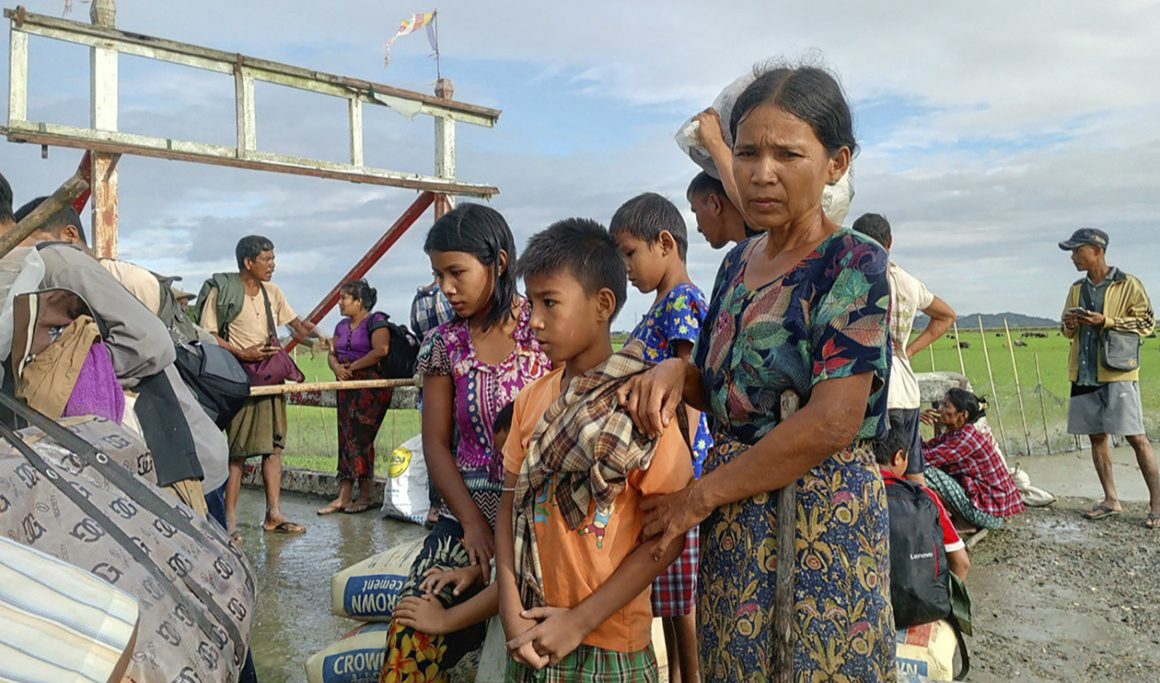 People flee from a village after renewed fighting between Myanmar’s military and the Arakan Army, an ethnic minority armed group, in Pauktaw Township in western Rakhine State on November 19, 2023. (AFP/File)