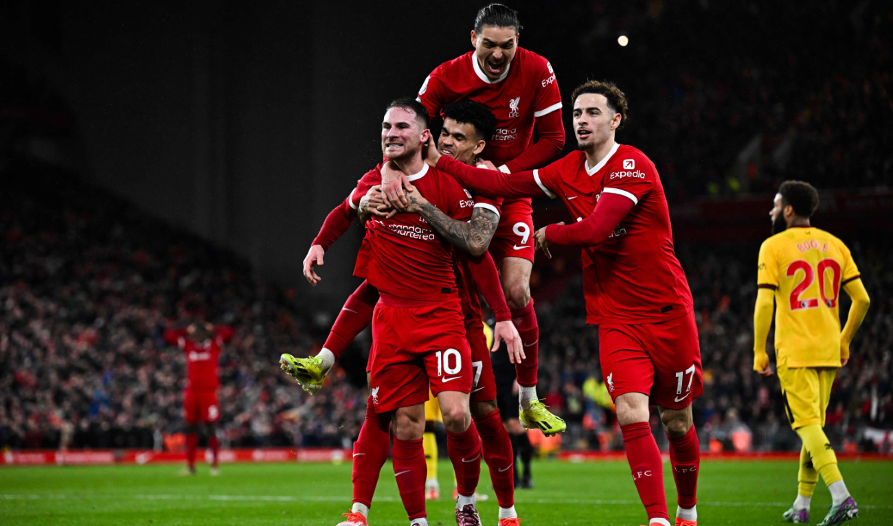 Liverpool's Argentinian midfielder #10 Alexis Mac Allister (L) celebrates with his teammates after scoring his team's second goal during the English Premier League football match between Liverpool and Sheffield United at Anfield in Liverpool, north west England on April 4, 2024. (AFP)