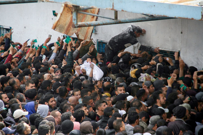 Palestinians gather to receive aid outside an UNRWA warehouse as Gaza residents face crisis levels of hunger, amid the ongoing conflict between Israel and Hamas, in Gaza City March 18, 2024. (REUTERS)