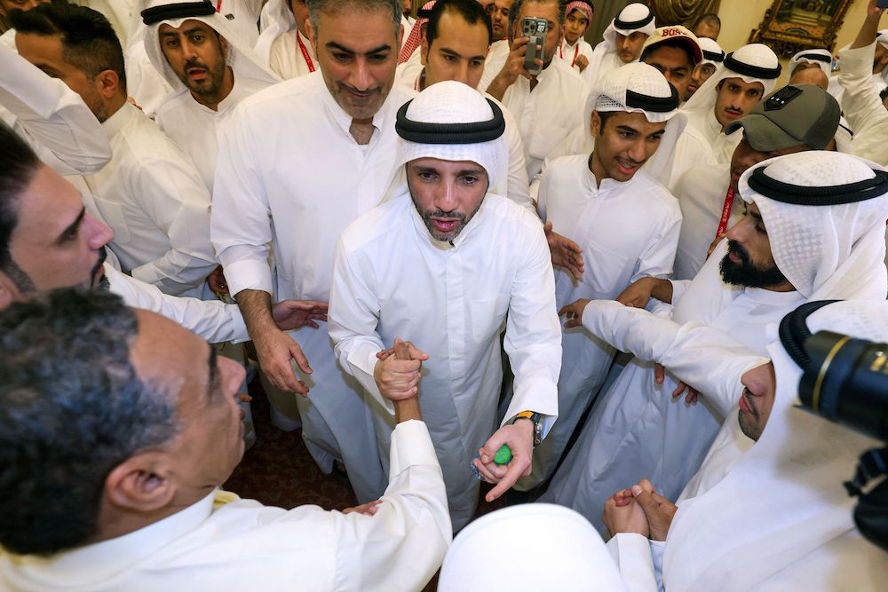 Former parliament speaker Marzouq al-Ghanim (C) greets supporters after his victory as a member of parliament in the legislative elections in Kuwait City early on April 5, 2024. (AFP)