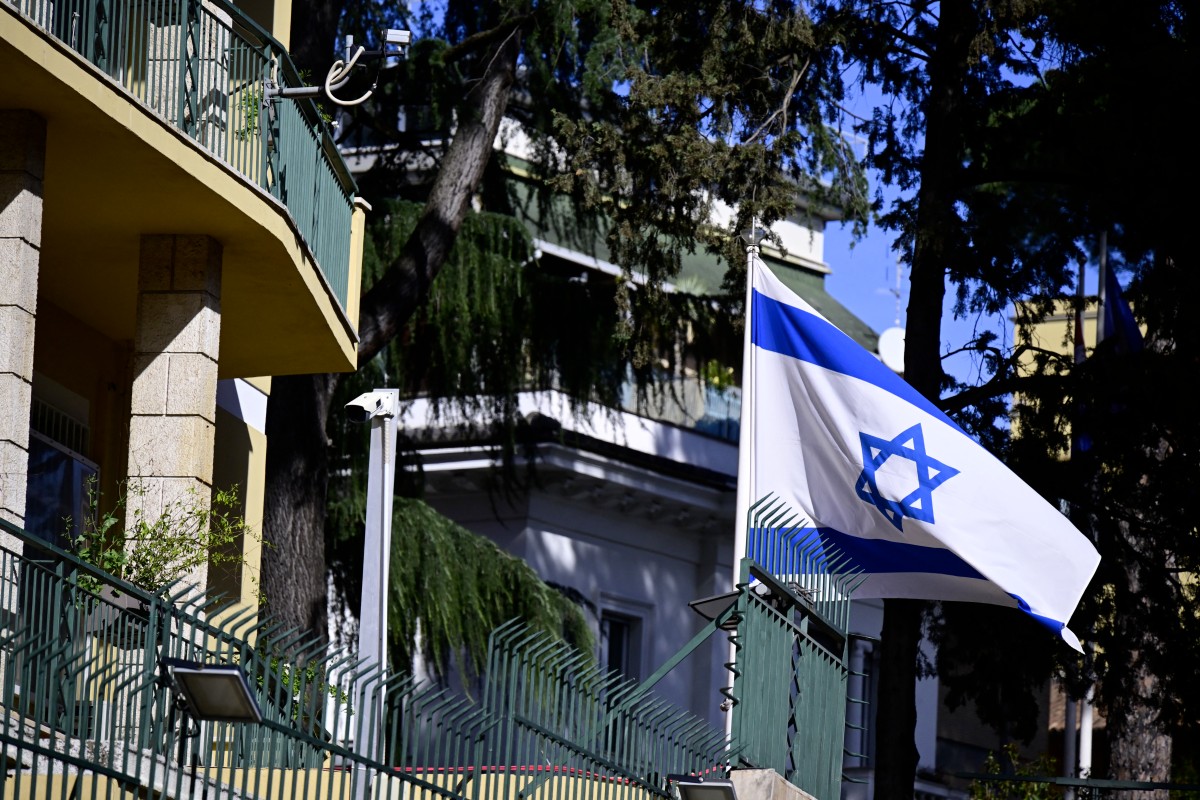A picture shows Israel's national flag at the entrance of Israeli embassy in Rome on April 5, 2024. (File/AFP)