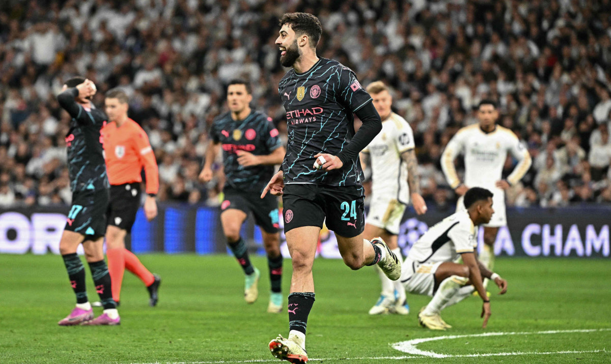 Manchester City's Croatian defender Josko Gvardiol celebrates scoring his team's third goal during the UEFA Champions League quarter final first leg football match between Real Madrid CF and Manchester City at the Santiago Bernabeu stadium in Madrid on April 9, 2024. (AFP)